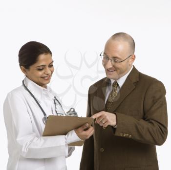 Royalty Free Photo of a Female Doctor Talking to a Businessman