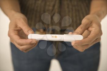 Royalty Free Photo of a Woman Holding a Pregnancy Test