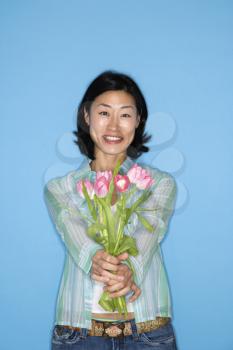 Royalty Free Photo of a Woman Holding Out Flowers