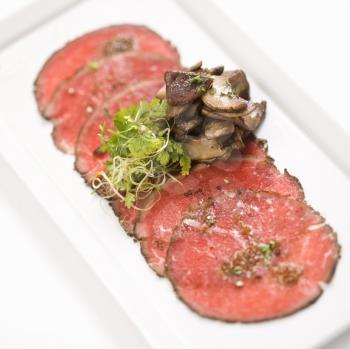 Royalty Free Photo of Pepper Charred Beef Carpaccio With Mushrooms