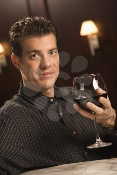 Royalty Free Photo of a Man Holding a Glass of Red Wine
