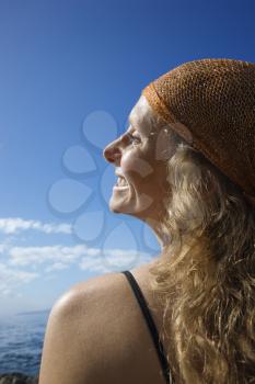 Royalty Free Photo of a Woman With Wavy Hair and Head Scarf at Coast