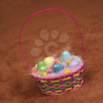 Royalty Free Photo of an Easter Basket Filled With Eggs and Candy