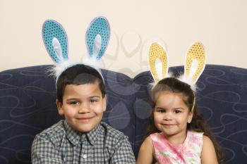 Royalty Free Photo of a Boy and Girl Wearing Bunny Ears Smiling 
