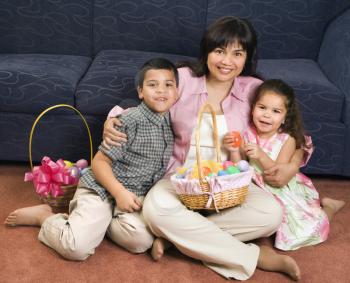 Royalty Free Photo of a Mother With Her Son and Daughter at Home With Easter Baskets