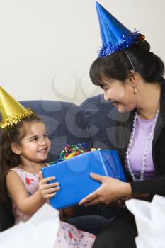 Royalty Free Photo of a Mother Giving Her Daughter a Present at a Birthday Party