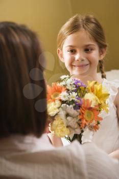 Royalty Free Photo of Girl Giving a Mother Flowers
