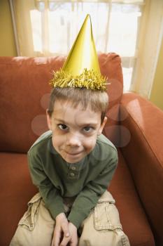 Royalty Free Photo of a Boy Wearing a Party Hat