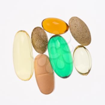 Close up of supplement vitamin pills against white background.