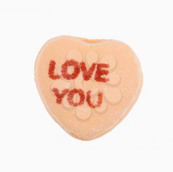 Royalty Free Photo of an Orange Candy Heart That Reads Love You