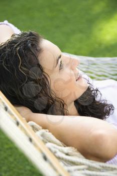 Royalty Free Photo of a Woman Lying in a Hammock and Smiling