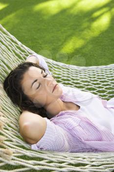 Royalty Free Photo of a Woman Lying in a Hammock With Hands Behind Her Head Sleeping