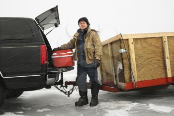 Royalty Free Photo of a Man Unloading a Cooler From a Truck in Green Lake, Minnesota, USA