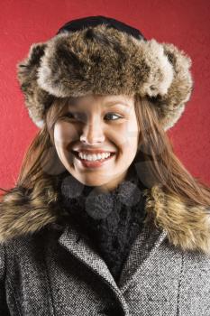 Royalty Free Photo of a Young Woman Wearing a Fur Hat Smiling