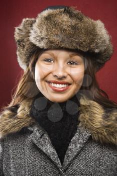 Royalty Free Photo of a Young Woman Wearing a Fur Hat Smiling