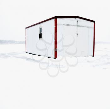 Royalty Free Photo of a Fish House on a Frozen Lake Green in Minnesota