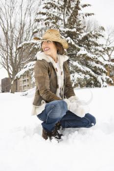 Royalty Free Photo of a Woman Leaning in the Snow Looking Over Her Shoulder