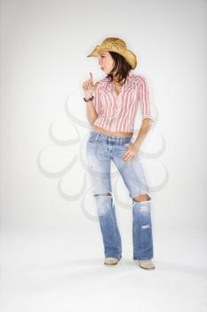 Royalty Free Photo of a Young Woman Wearing a Cowboy Hat Pointing Finger Upwards Like a Gun