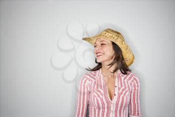 Royalty Free Photo of a Woman Wearing a Cowboy Hat Smiling