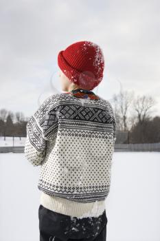 Royalty Free Photo of a Boy Wearing a Sweater and a Red Winter Cap