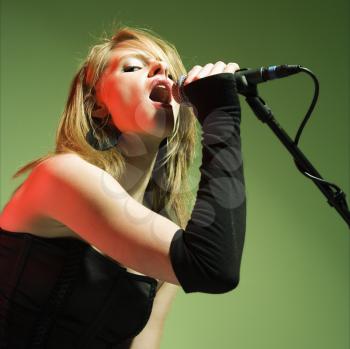 Royalty Free Photo of a Woman Singing into a Microphone