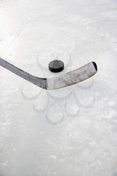 Royalty Free Photo of a Close-up of an Ice Hockey Stick on an Ice Rink in Position to Hit a Hockey Puck