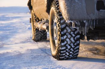Royalty Free Photo of a Close-up of a Truck on an Ice Covered Road