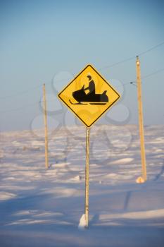 Royalty Free Photo of a Snowy Landscape With a Snowmobile Crossing Sign