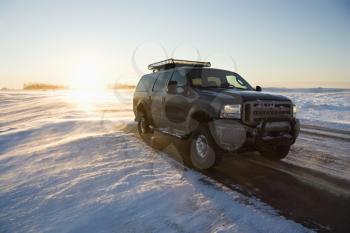 Royalty Free Photo of a Truck on an Icy Road With Snowy Landscape