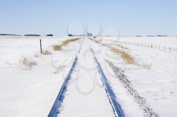 Royalty Free Photo of Railroad Tracks in Snow Covered Rural Landscape