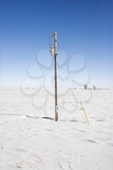Royalty Free Photo of a Power Line in Desolate Snow Covered Rural Landscape