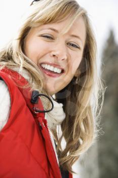 Royalty Free Photo of a Smiling Blond Woman Wearing a Red Ski Vest