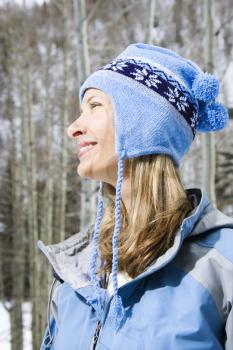 Royalty Free Photo of a Profile of a Smiling Blond Woman Wearing a Blue Ski Cap