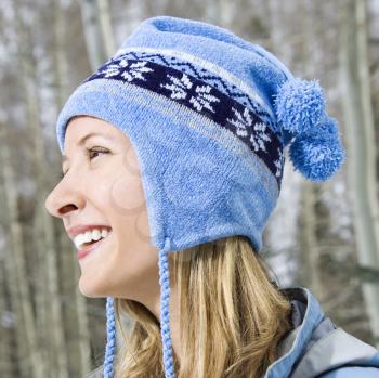 Royalty Free Photo of a Profile Headshot of an Attractive Smiling Blond Woman Wearing a Blue Ski Cap