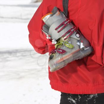 Royalty Free Photo of a Close-up of a Ski Boot Over the Shoulder a Teenager