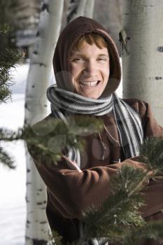 Portrait of a Caucasian male teenager wearing hoodie and scarf in winter setting.