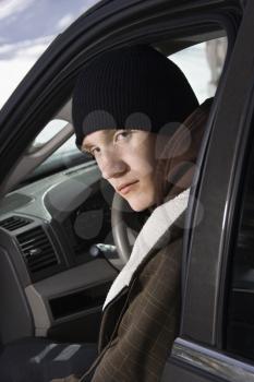 Royalty Free Photo of a Male Teenager Sitting in a Car