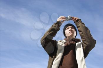 Royalty Free Photo of a Teenager Taking a Picture With a Digital Camera