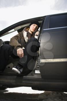 Royalty Free Photo of a Confident Male Teenager Sitting in a Car
