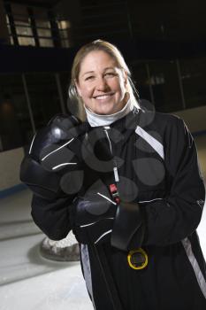 Royalty Free Photo of a Female Hockey Coach in a Uniform Standing and Smiling