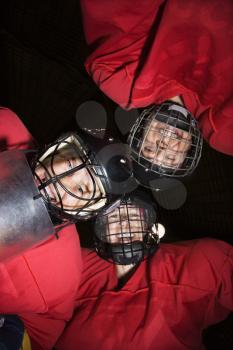 Royalty Free Photo of a Low Angle of Female Hockey Players in a Huddle Smiling