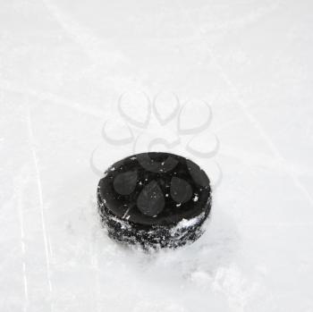 Royalty Free Photo of a Black Hockey Puck on an Ice Rink