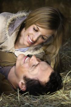 Royalty Free Photo of a Couple Laying in Hay 