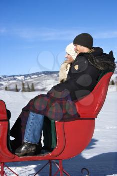 Royalty Free Photo of a Young Couple in a Sleigh