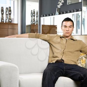 Royalty Free Photo of a Man Sitting on a Couch