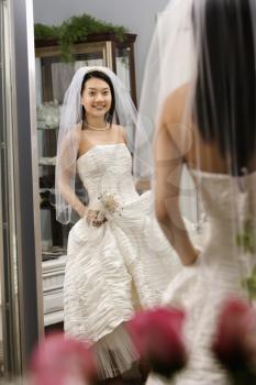 Royalty Free Photo of a Bride Admiring Herself in the Mirror
