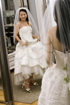 Royalty Free Photo of a Bride Admiring Her Shoes in the Mirror