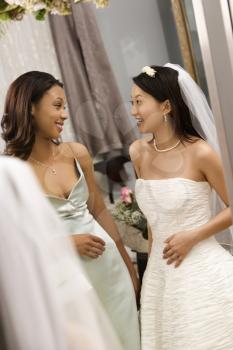 Royalty Free Photo of a Bride and Bridesmaid Talking to Each Other