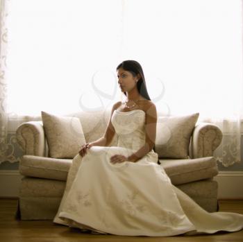 Royalty Free Photo of an Indian Bride Sitting on a Love Seat
