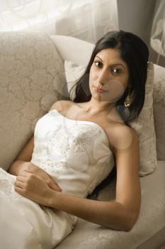 Royalty Free Photo of an Indian Bride Lying on a Love Seat